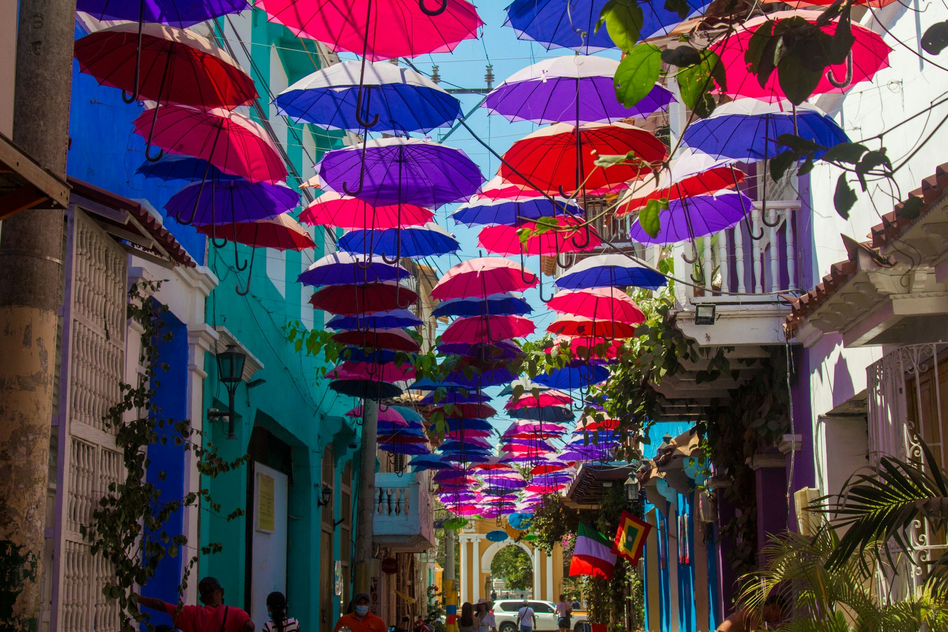 Colorful umbrellas hanging over a cobblestone street in Cartagena, Colombia